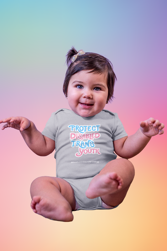 A very cute white baby smiles while wearing a gray onesie that reads, “Protect Disabled Trans Youth” in hand drawn letters in the trans pride flag colors (light pink, sky blue, and white). Below is the white Disability Culture Lab logo.