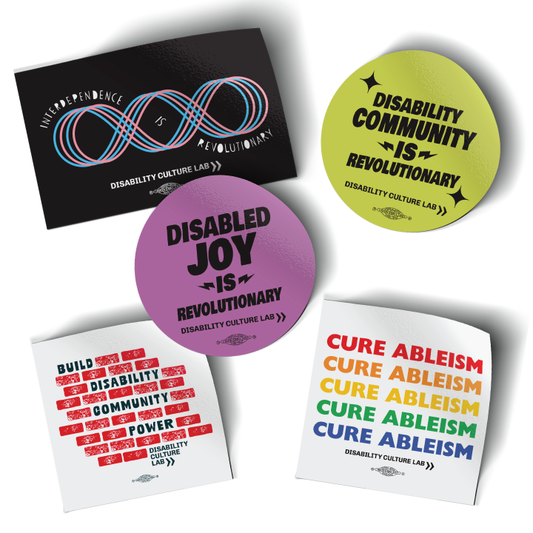 Five stickers on a white background. From left to right, top to bottom: "Interdependence is Revolutionary" sticker in black. "Disability Community is Revolutionary" sticker in yellow. "Disabled Joy is Revolutionary" sticker in purple. "Build Disability Community Power" sticker in white. "Cure Ableism" sticker in rainbow colors on white background.